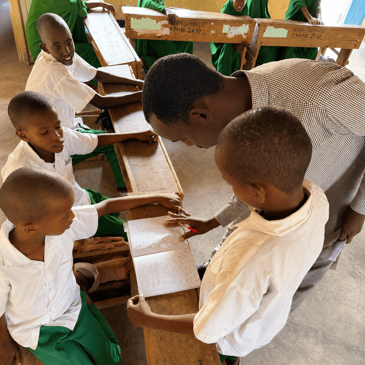 Teacher assisting learners during an interactive classroom lesson in a rural school supported by eduLET Africa, promoting inclusive and accessible quality education for all.